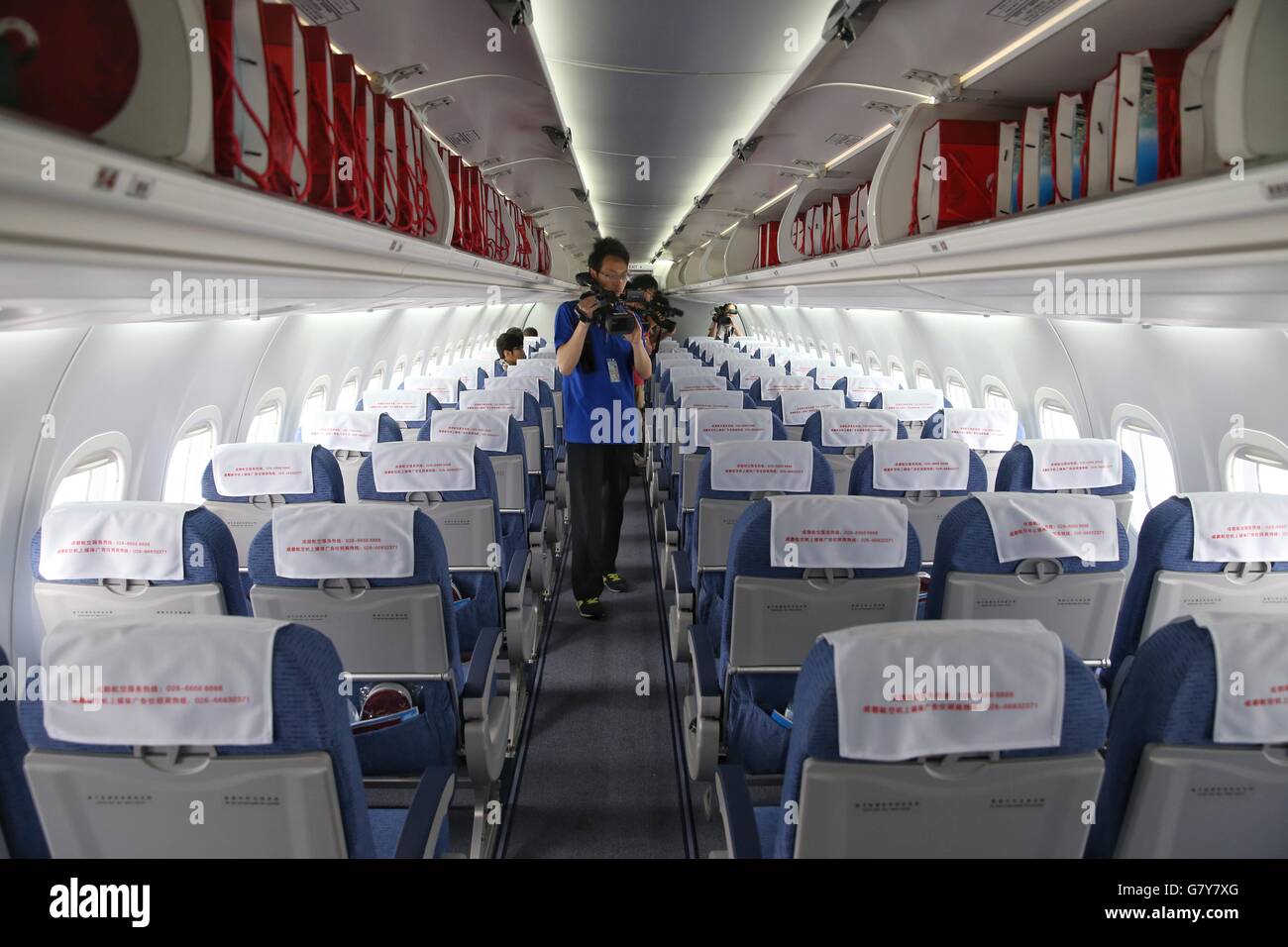 Chengdu, China's Sichuan Province. 28th June, 2016. Reporters work inside Chengdu Airlines ARJ21-700 at Shuangliu International Airport in Chengdu, capital of southwest China's Sichuan Province, June 28, 2016. ARJ21, manufactured by the Commercial Aircraft Corp. of China (COMAC), made its maiden commercial flight from Chengdu to Shanghai Tuesday. The domestically-designed airliner is China's first regional jet manufactured according to international standards. © Liu Kun/Xinhua/Alamy Live News Stock Photo