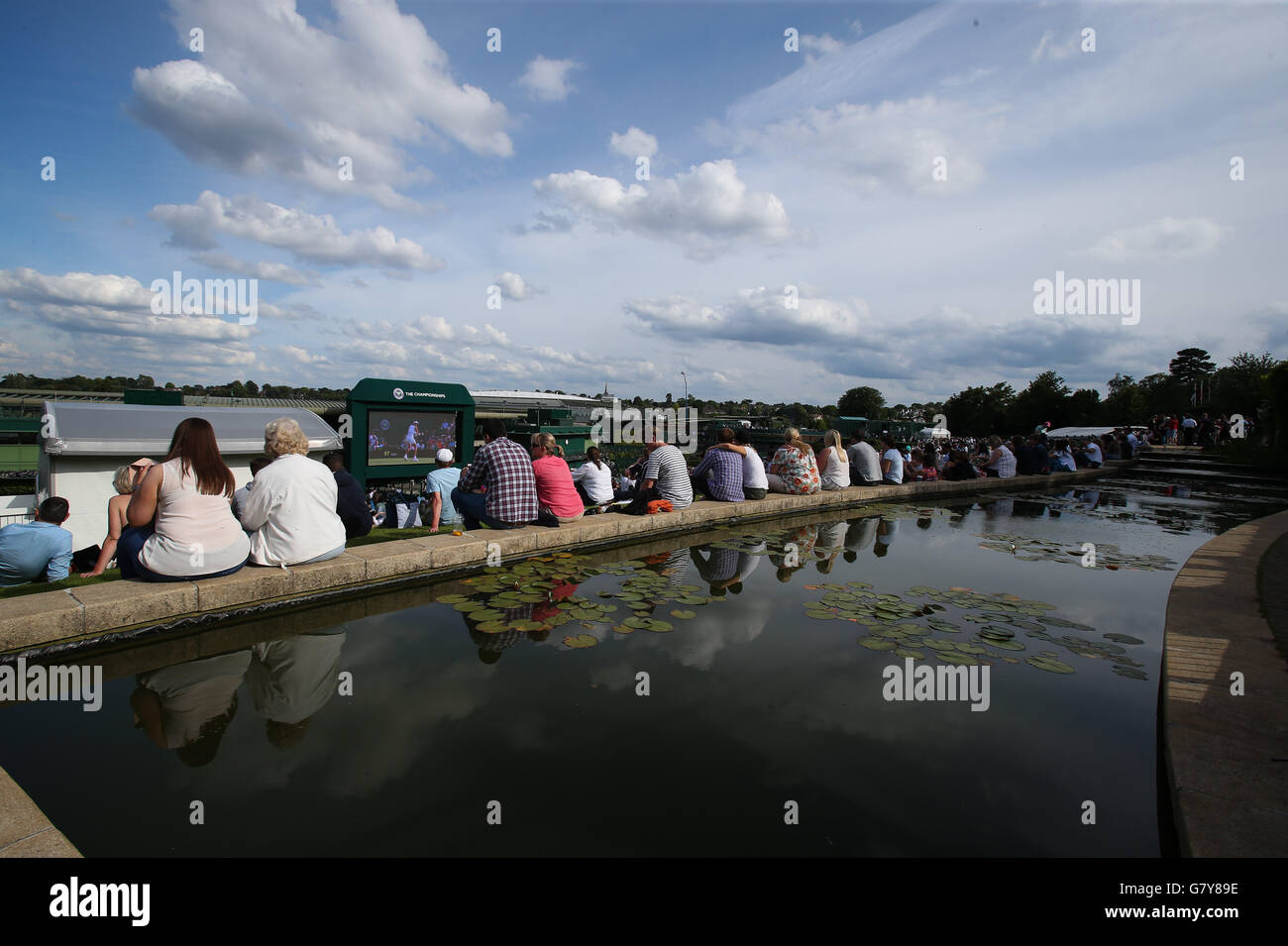 London, UK. 27th June, 2016. Spectators watch a giant screen as they sit on Murray Mount (Henman Hill) on Day 1 at the 2016 Wimbledon Tennis Championships in London June 27, 2016. © Han Yan/Xinhua/Alamy Live News Stock Photo