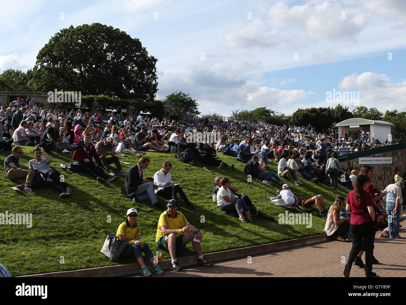 London, UK. 27th June, 2016. Spectators sit on Murray Mount (Henman Hill) on Day 1 at the 2016 Wimbledon Tennis Championships in London June 27, 2016. © Han Yan/Xinhua/Alamy Live News Stock Photo