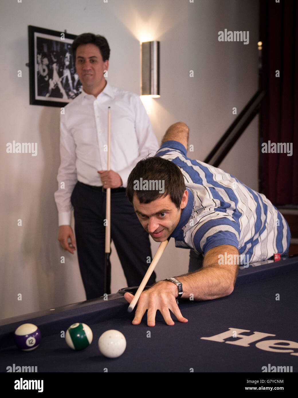 Previously unissued photo dated 23/04/15 of Labour leader Ed Miliband playing pool with Snooker player Ronnie O'Sullivan at the Common Room Pool hall in Sheffield. Stock Photo