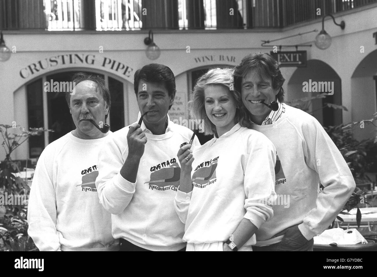 Pipe-smoking actress Tracey Childs joins fellow pipe fans (l-r) TV sports presenter Jimmy Greaves, actor Tony Anholt and property entrepreneur 'Bungalow' Bill Wiggins in London's Covent Gardens. They are launching The Pipesmokers' Council's 'Give It A Go' challenge for 1988. Along with Pipesmoker of the Year Ian Botham, the team will aim to dispel the old armchair and slippers image of pipe smoking by participating in unusual events such as sheep shearing, winch grinding and scurry driving. Stock Photo