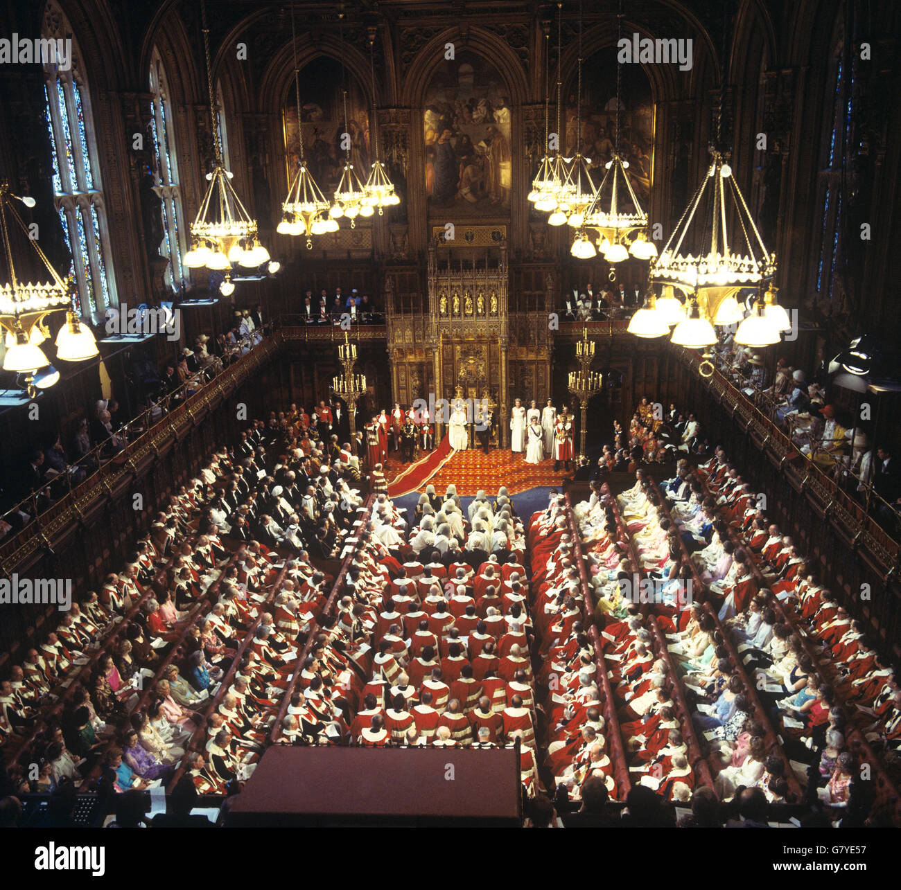 Queen Elizabeth II delivers a speech as she opens Parliament in the House of Lords. Next to the Queen is the Duke of Edinburgh, with Prince Charles and Princess Anne seated nearby. Stock Photo