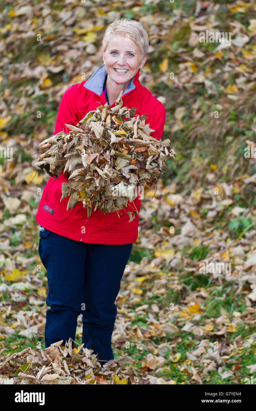 Gardening, woman putting away leaves Stock Photo - Alamy