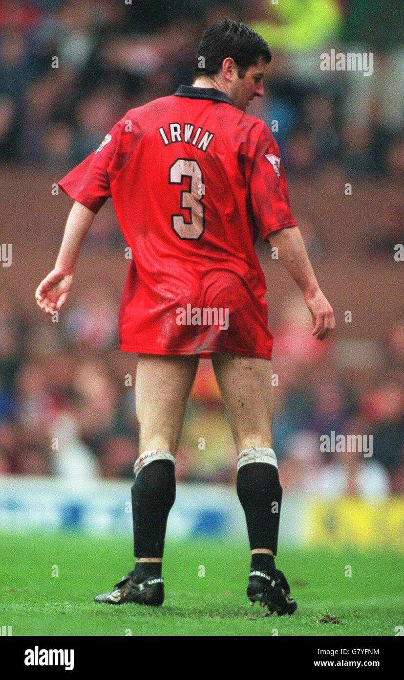 Denis Irwin of Manchester United changes his shorts at the side of the