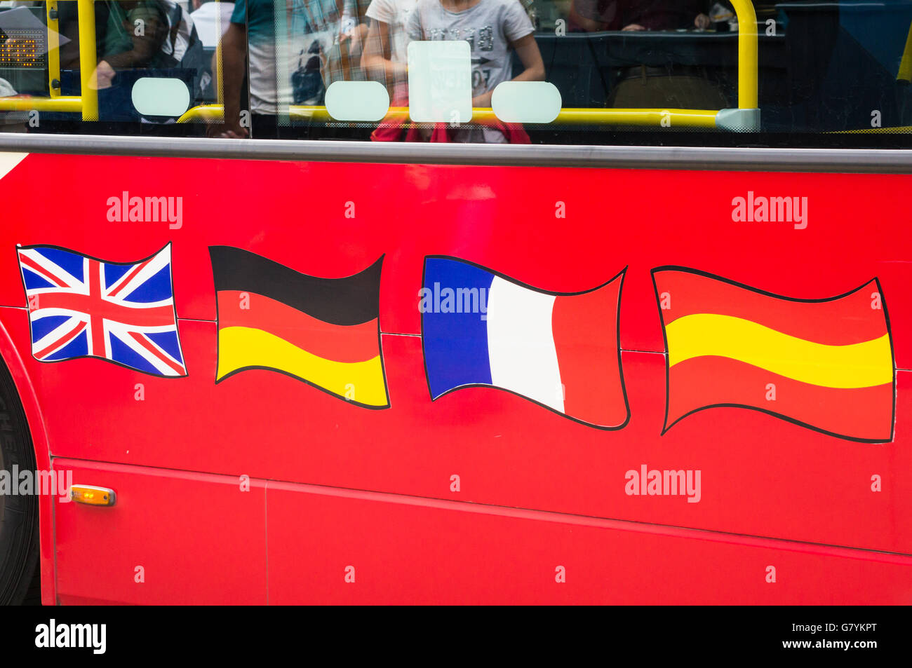 British, German, French and Spanish flags on a London tour bus, London, England Stock Photo