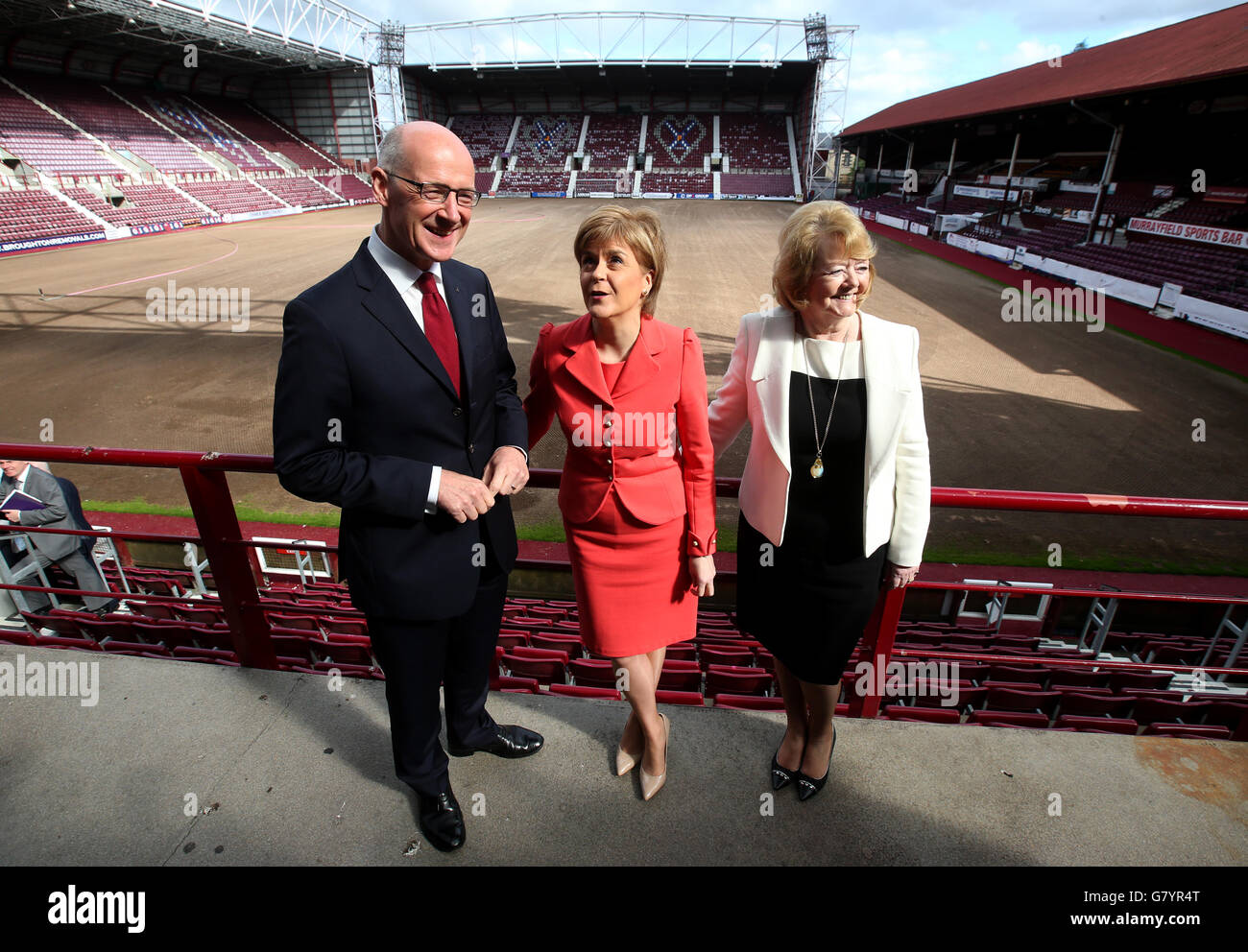 Scotland's First Minister Nicola Sturgeon and Deputy First Minister John Swinney with Heart of Midlothian Football Club Chairwoman Ann Budge (right) at Tyncastle Stadium in Edinburgh for her first major economic speech since the general election. Stock Photo