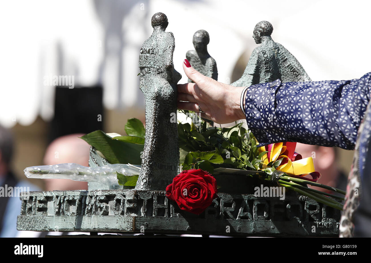 People attend a memorial service for the 30th anniversary of the deaths