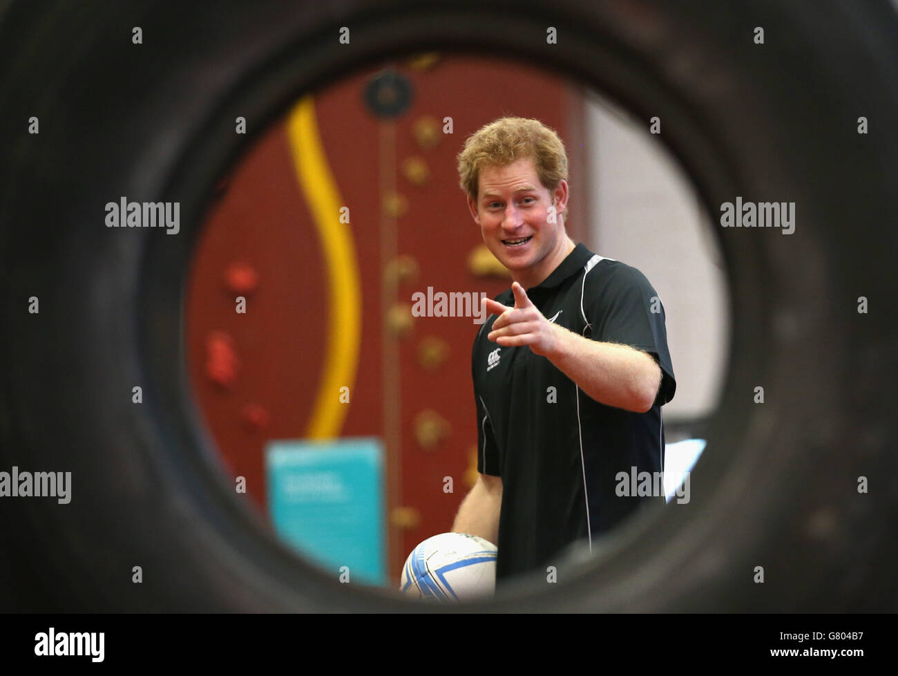 Prince Harry, throwa a rugby ball through a tyre as he takes part in a training excercise at the AUT Millennium Institute of Sport and Health, in Auckland, on the eighth and final day of his visit to New Zealand. Stock Photo