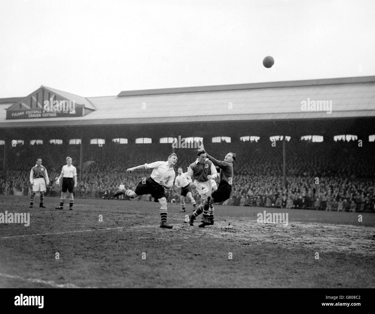 Fulham's Ron Greenwood (l) heads over his own bar as Ipswich Town's Tom Garneys (c) puts pressure on Fulham goalkeeper Ian Black (r) Stock Photo