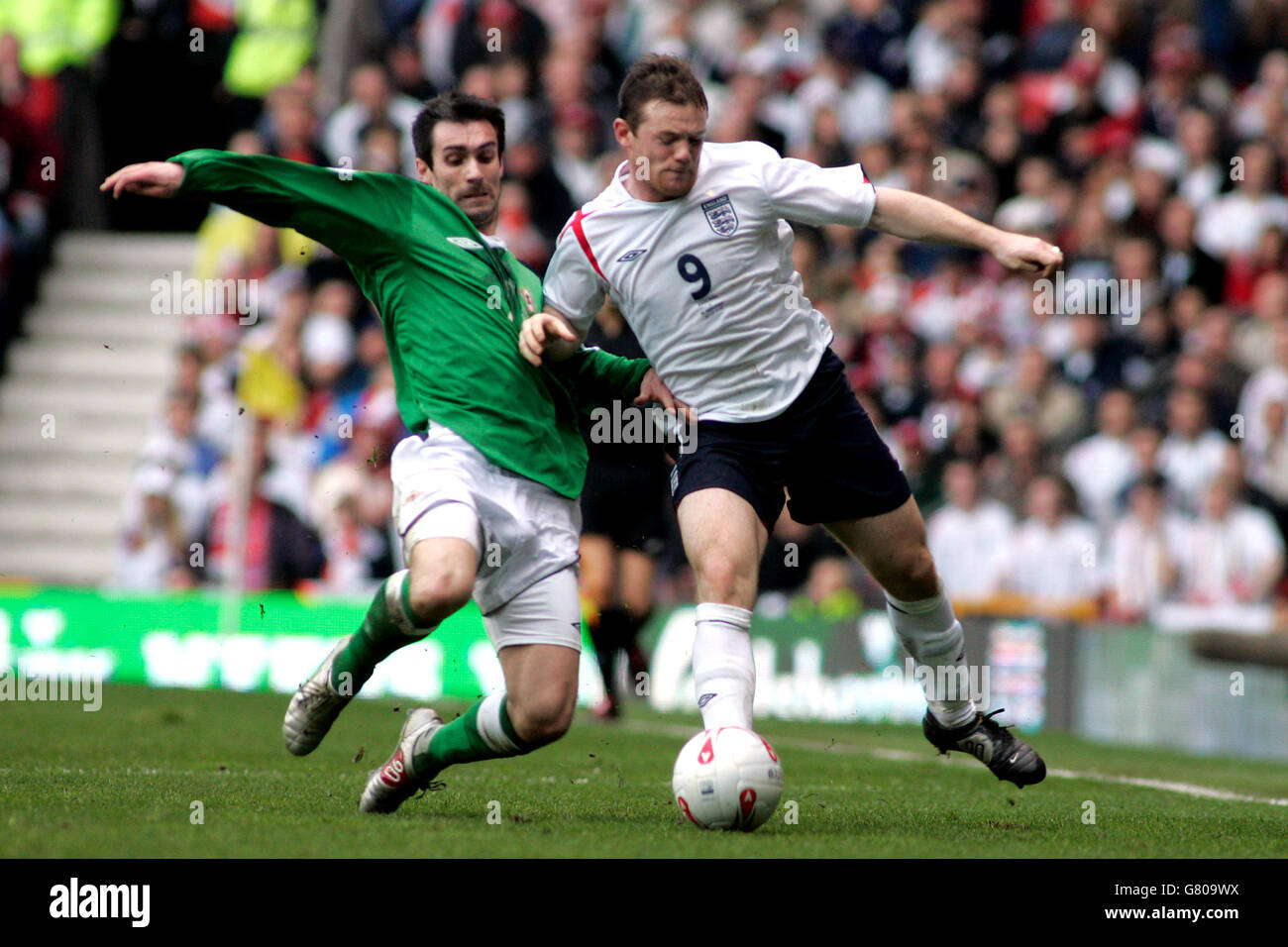 Soccer - FIFA World Cup 2006 Qualifier - Group Six - England v Northern Ireland - Old Trafford. England's Wayne Rooney and Northern Ireland's Keith Gillespie Stock Photo