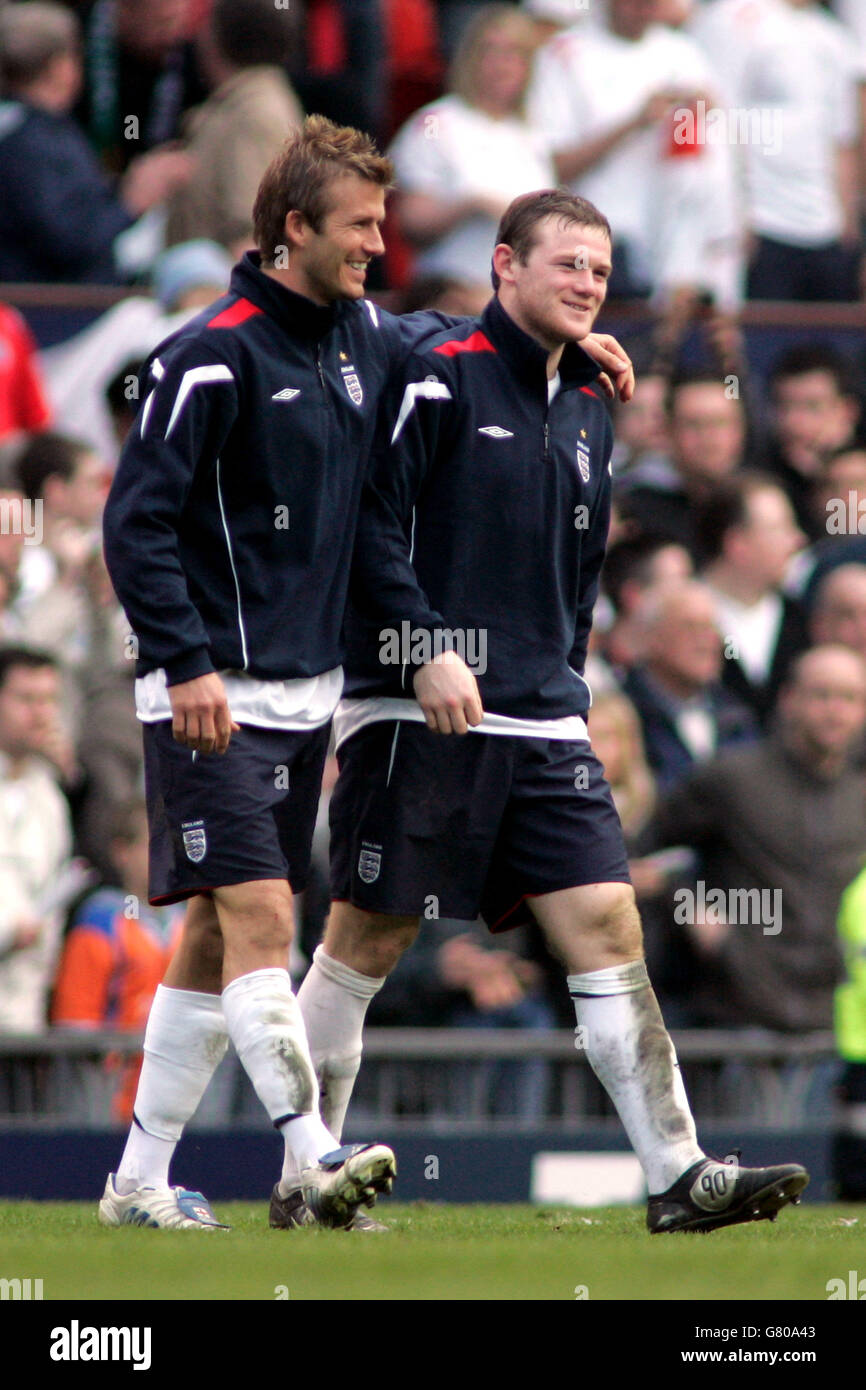 Soccer - FIFA World Cup 2006 Qualifier - Group Six - England v Northern Ireland - Old Trafford. England's David Beckham and Wayne Rooney walk on the pitch following Englands win against Northern Ireland Stock Photo