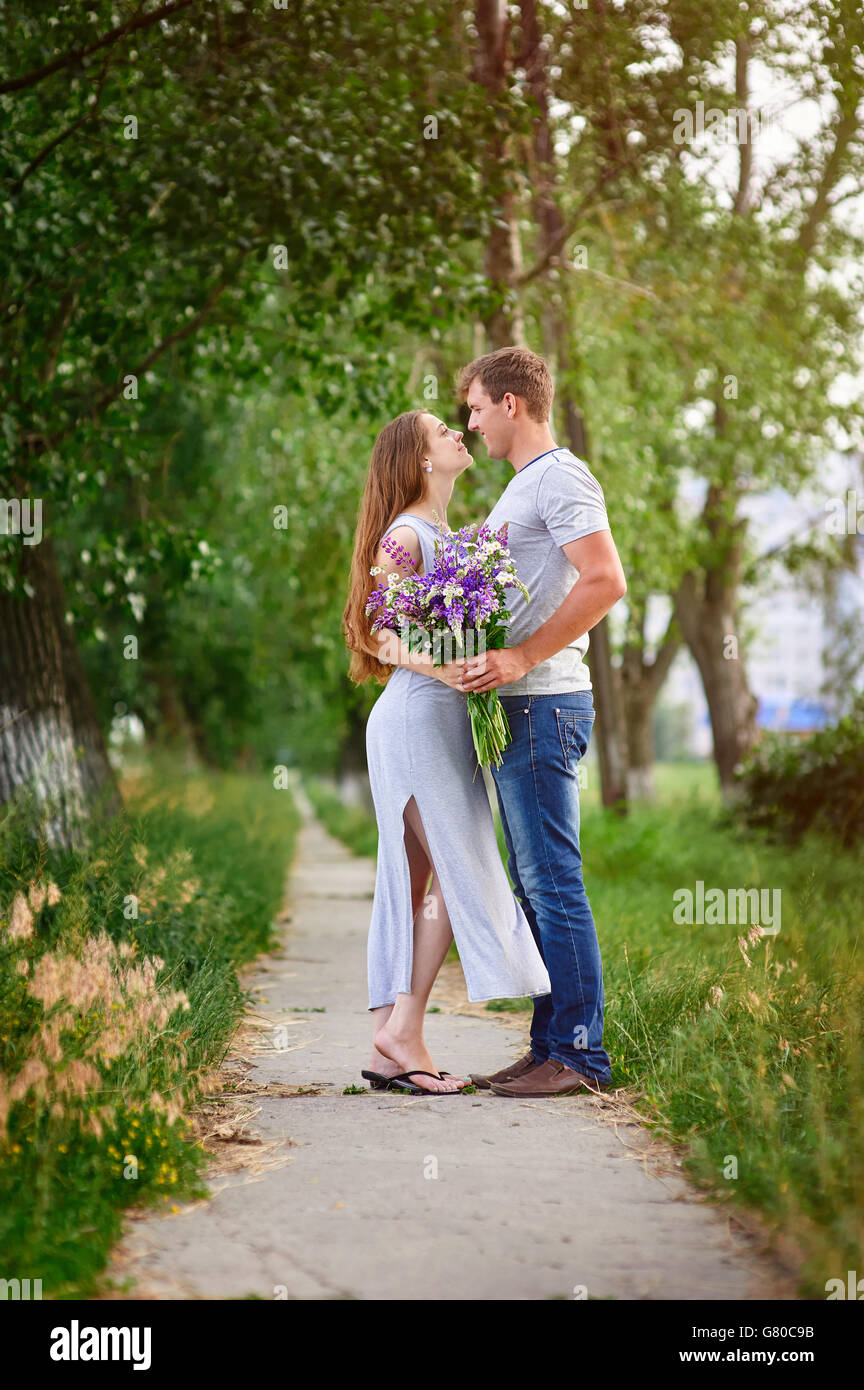 portrait of young stylish fashion couple in field looking on each other Stock Photo
