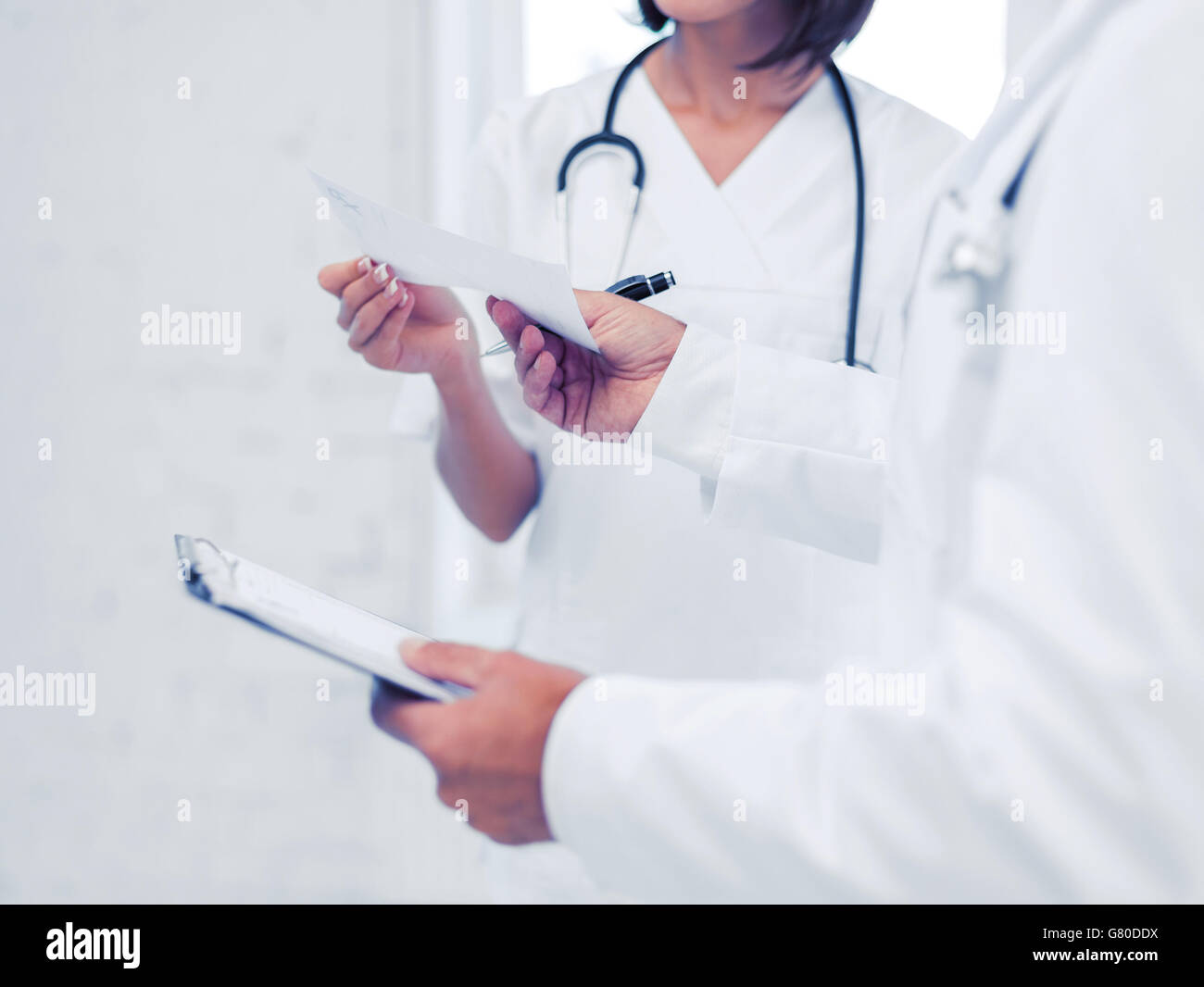 two doctors writing prescription Stock Photo Alamy