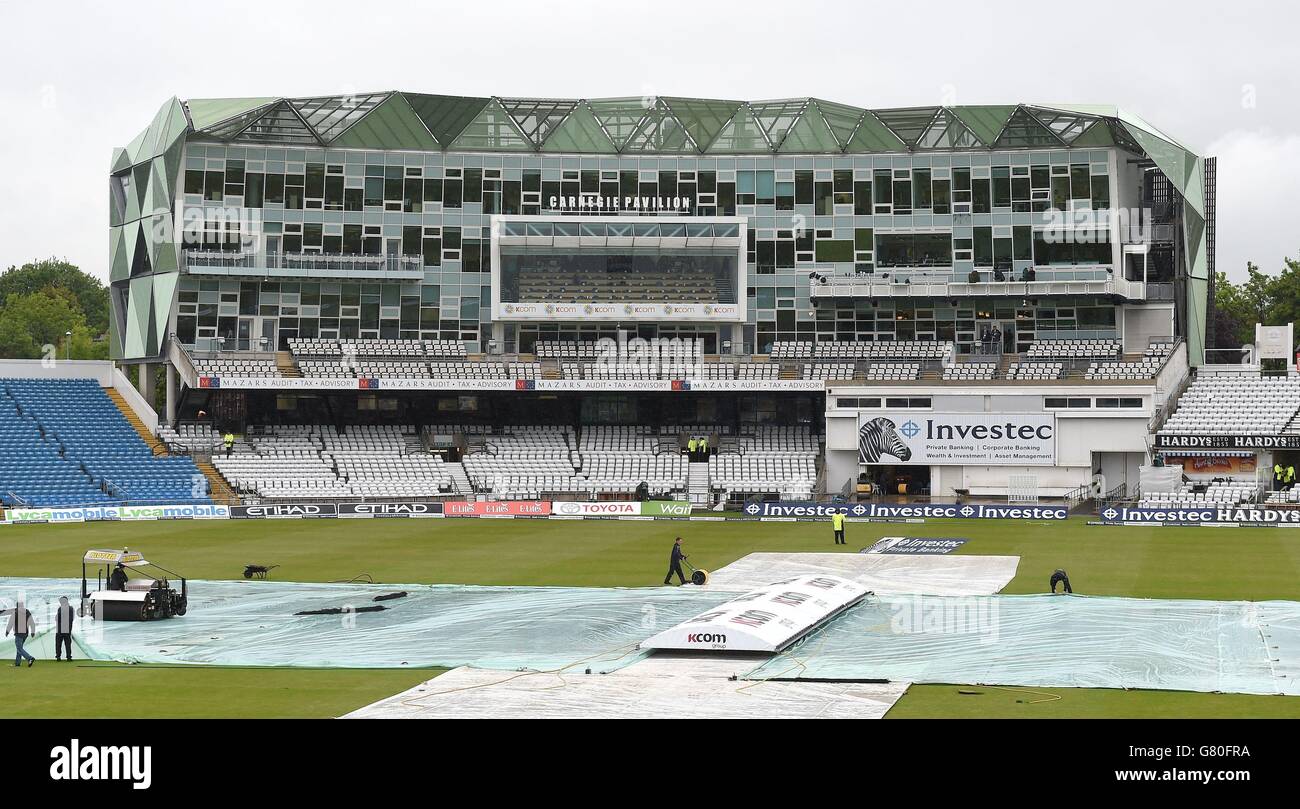 Ground staff attempt to clear rain water from the wicket before the Investec Second Test between England and New Zealand at Headingley, Leeds. Stock Photo