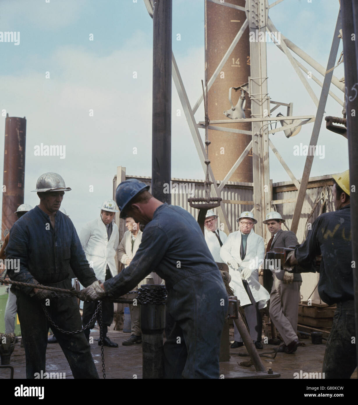 Mr Fred Lee, Minister of power, and members of his party walking along the deck of the drilling rig 'Sea Gem' in the North Sea off Grimsby. Stock Photo