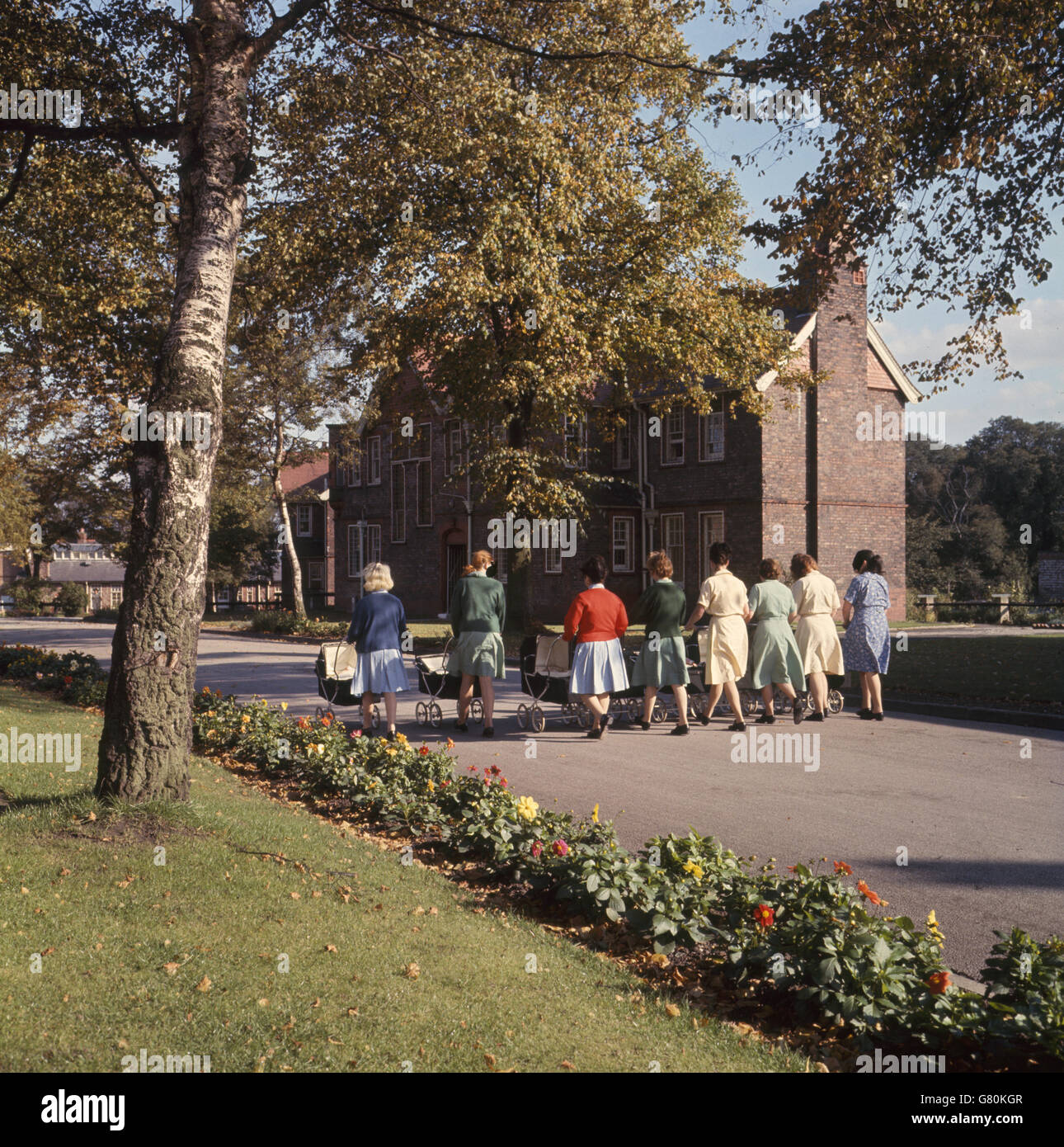 Mothers with prams walking through the avenues at Styal Women's Prison. The prison opened in 1963. Stock Photo