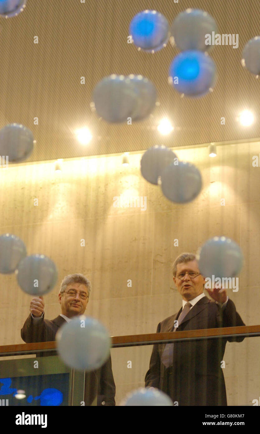 Patrick Cescau (left), the chairman of Unilever and Chris Gibson-Smith, Chairman of the London Stock Exchange officially open the markets for trading on the 75th anniversary of the formation of Unilever, inside the London Stock Exchange. Stock Photo