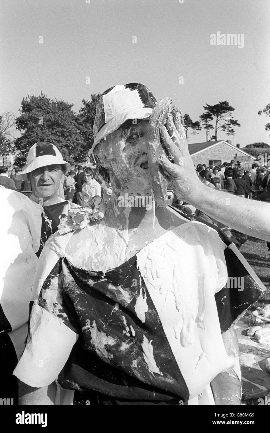 A gooey mess lands in the face of a fellow competitor during the Third World Custard Pie Championships held at Coxheath, near Maidstone. Stock Photo