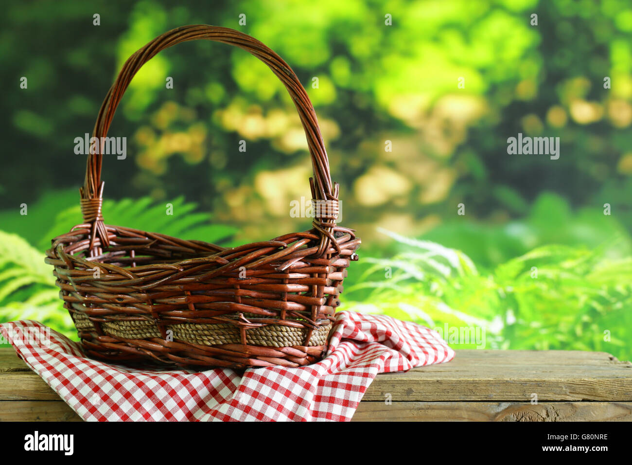 empty wicker basket and checkered plaid for picnic Stock Photo Alamy