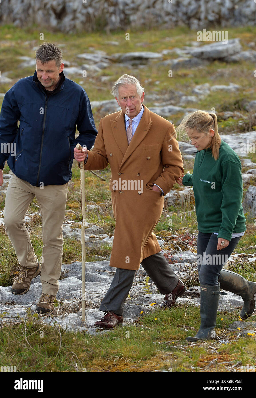 The Prince of Wales is escorted by Brigid Barry and Brendan Dunford, during his visit to the Burren in County Clare, an ancient and dramatic stony outcrop famed for its rare plant life, biodiversity and archaeology on on the first day of his Royal visit to the Republic of Ireland. Stock Photo