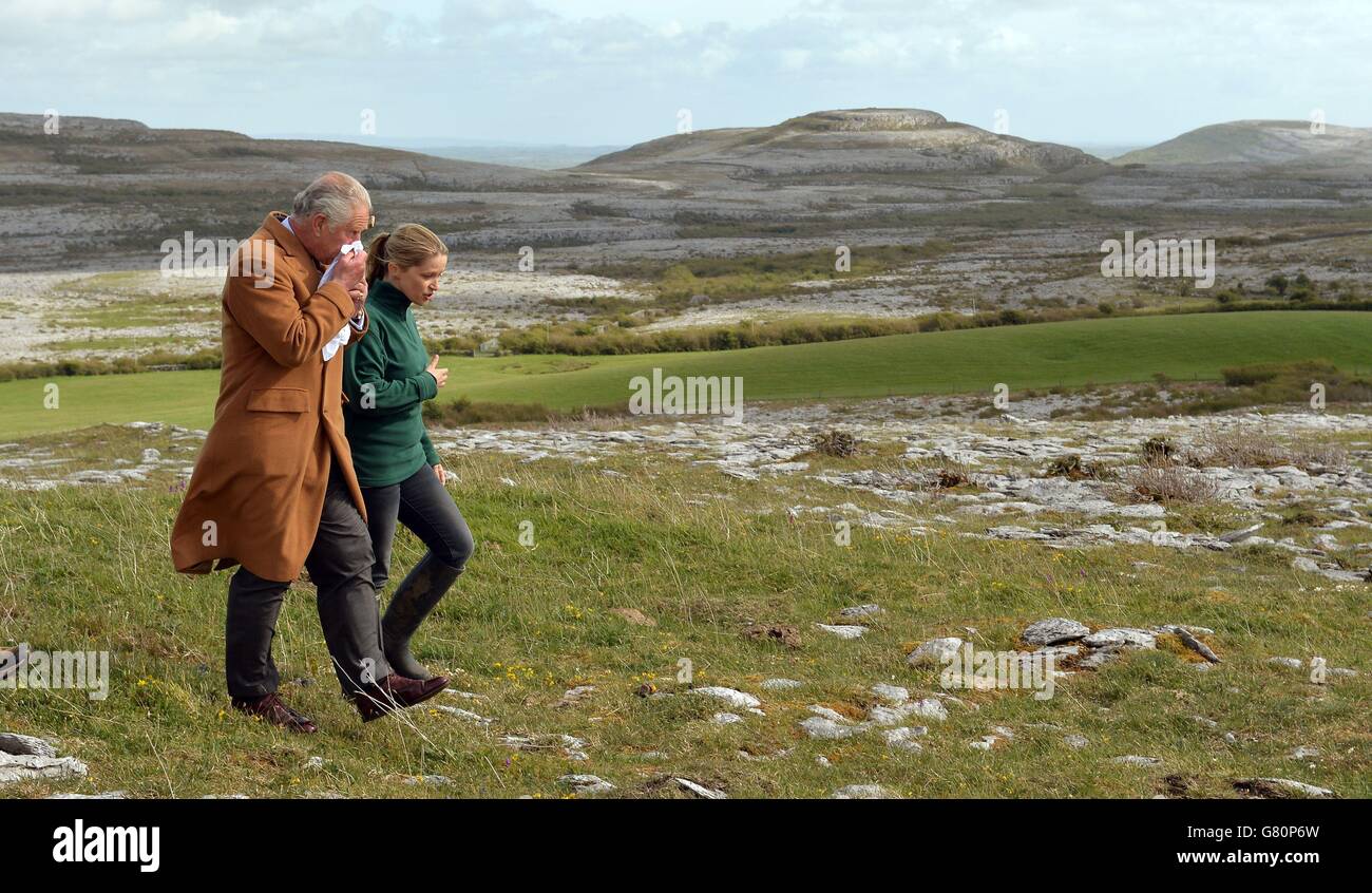 The Prince of Wales walks beside Brigid Barry up on the higher ground during his visit to the Burren in County Clare, an ancient and dramatic stony outcrop famed for its rare plant life, biodiversity and archaeology on on the first day of his Royal visit to the Republic of Ireland. Stock Photo