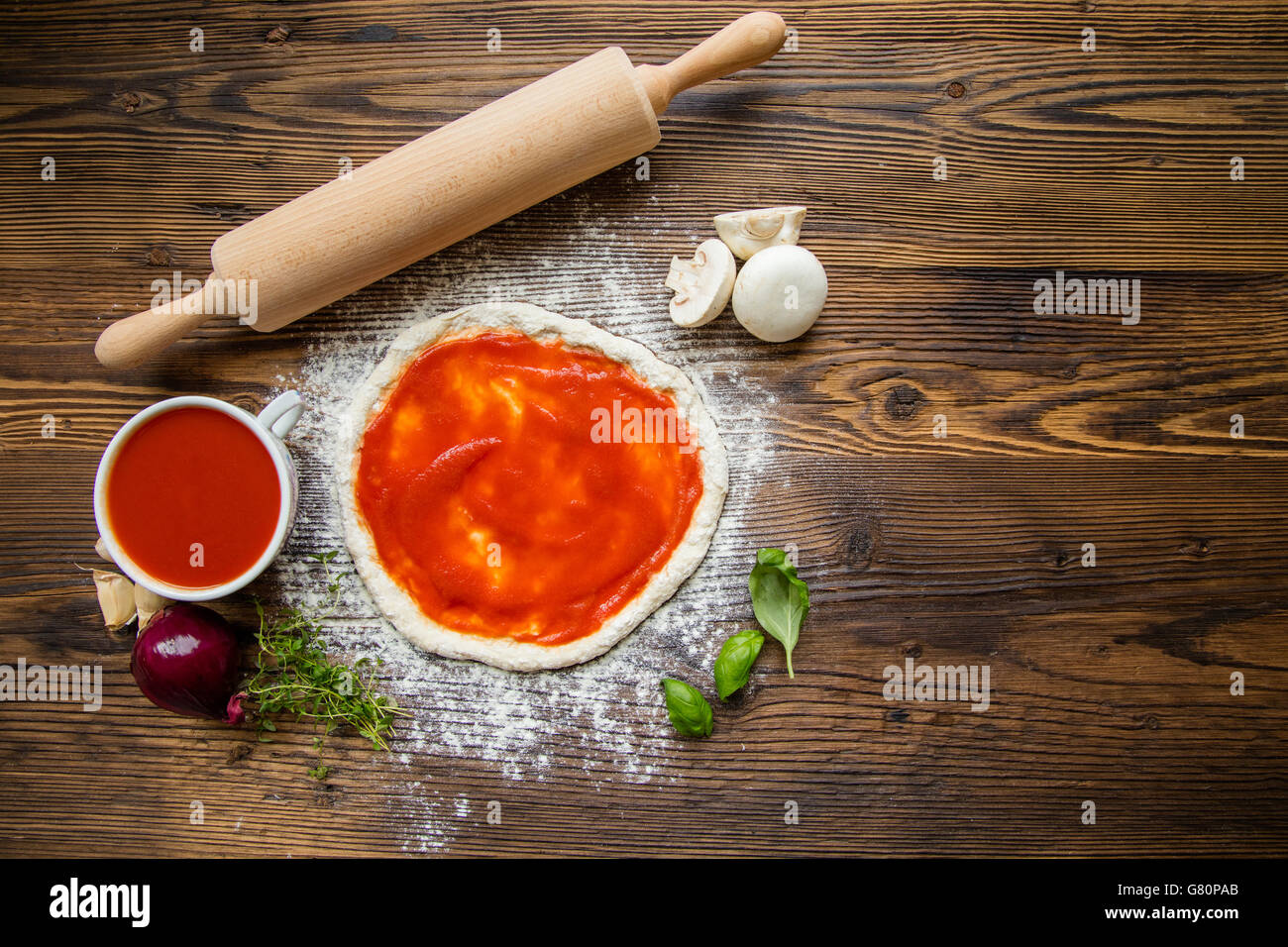 Pizza dough with ingredients, tomato sauce and wooden rolling-pin served on  rustic wooden table. Aerial shot, copyspace for text Stock Photo - Alamy