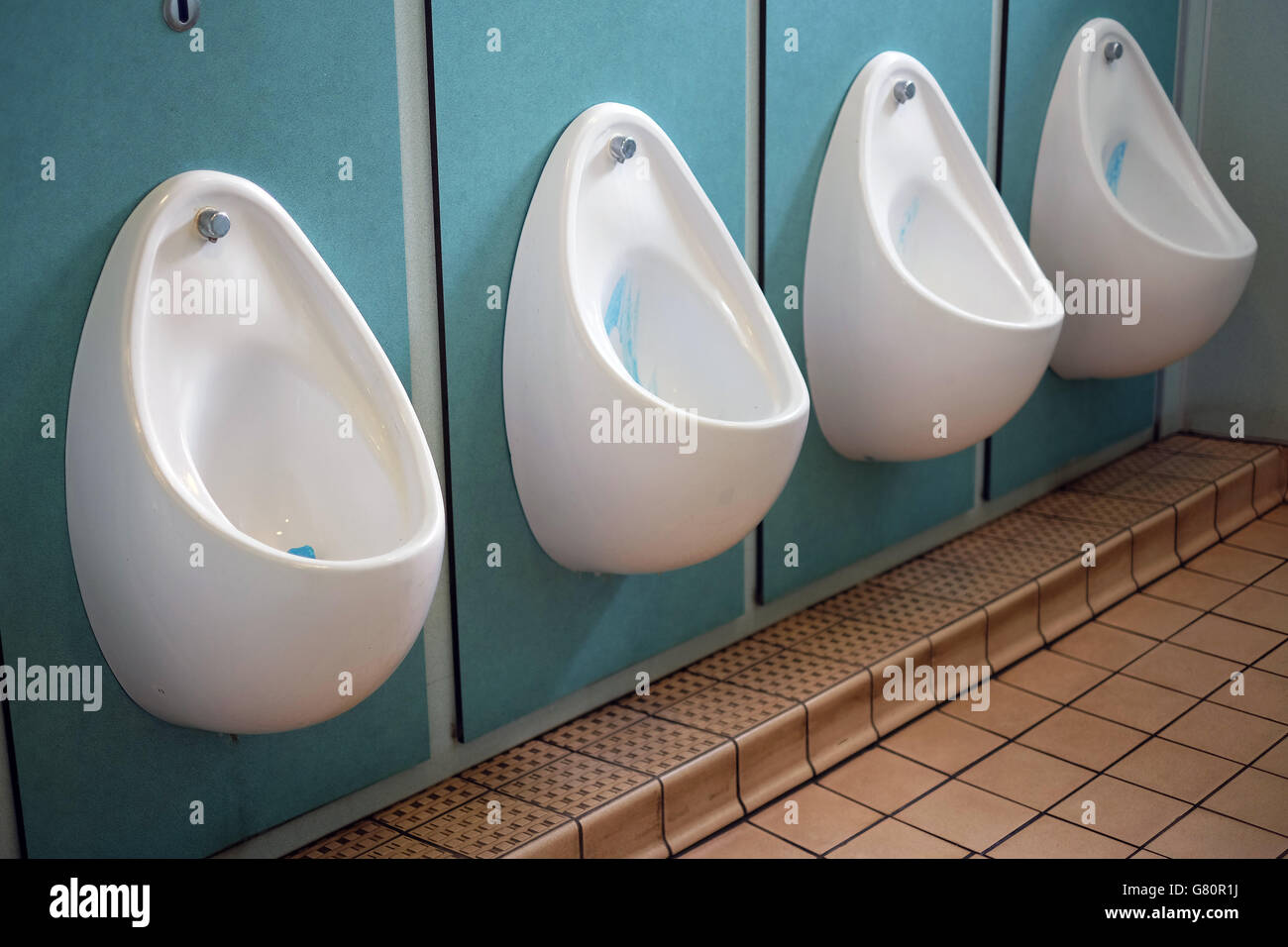 Inside mens urinals. Stock Photo