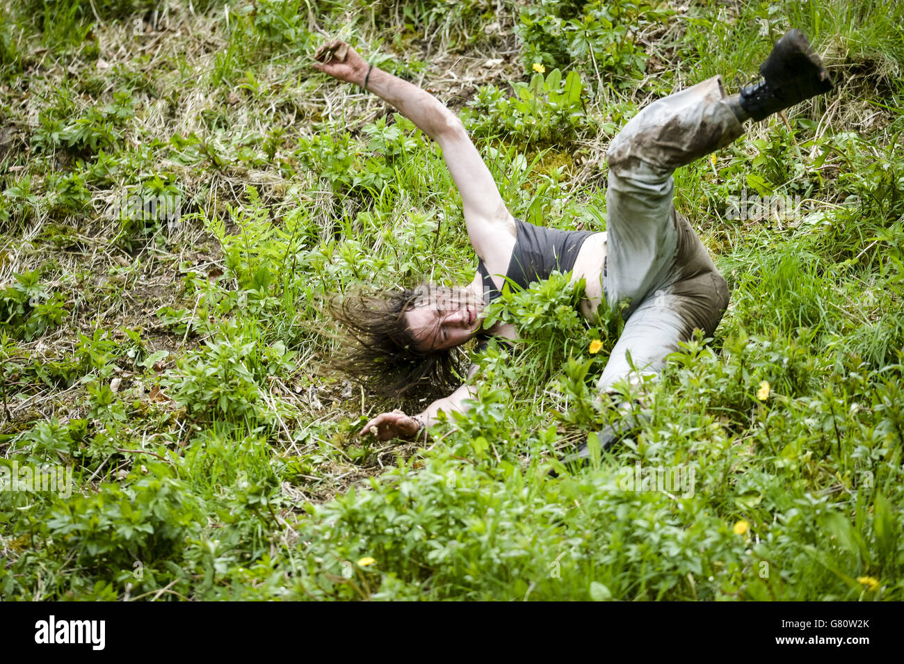 A man crashes and tumbles as he chases after the Double Gloucester cheese as it hurtles down Coopers Hill, Gloucestershire, in the annual Cheese Rolling competition, which is being held unofficially this year. PRESS ASSOCIATION Photo. Picture date: Monday May 25, 2015. Photo credit should read: Ben Birchall/PA Wire Stock Photo