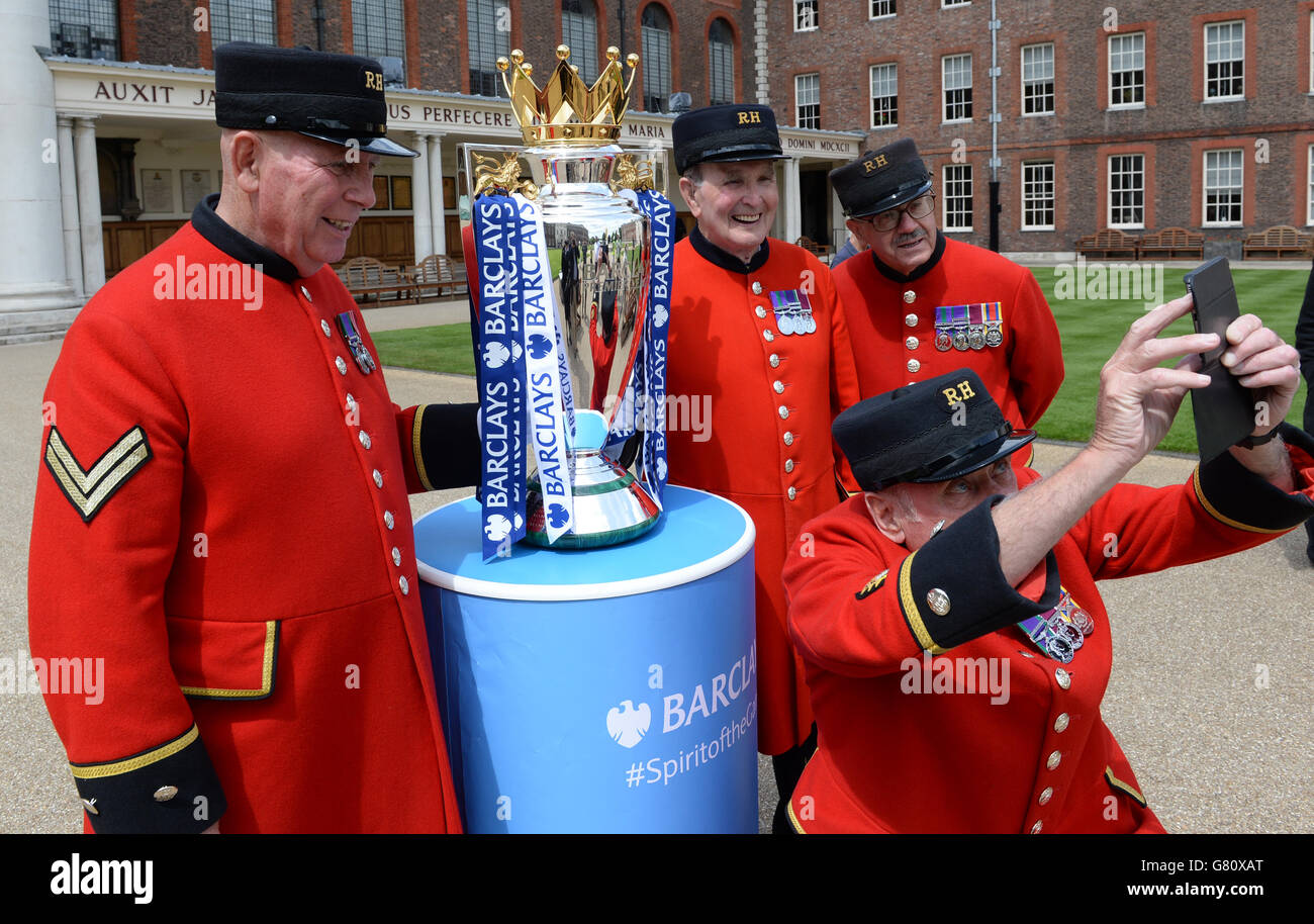 Chelsea Pensioners photograph themselves with the Premier League trophy at the Royal Hospital Chelsea in London today which was lent to them by the champions, Chelsea. PRESS ASSOCIATION Thursday May 28 2015. Photo credit should read: Stefan Rousseau/PA Wire Stock Photo