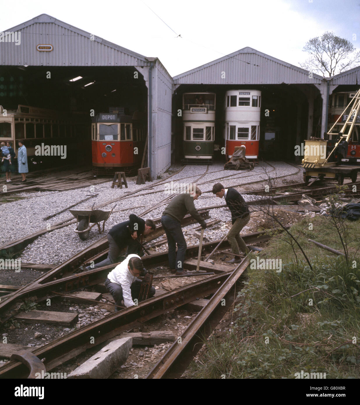 Volunteers carry out maintenance work in front of the tram sheds at Crich Tramway Museum, Derbyshire. Stock Photo