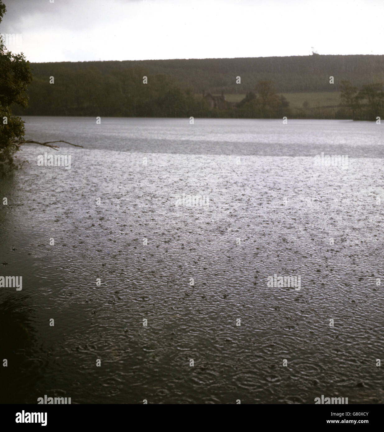 Rain pours onto the reservoir at Chatsworth House which comes from the