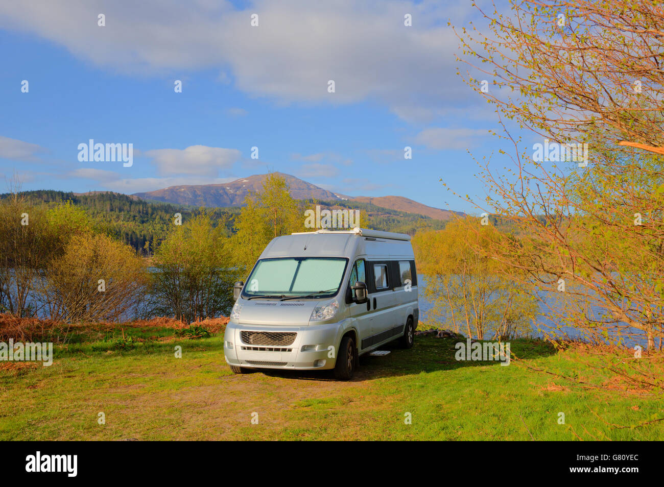 Campervan wildcamping in Scotland by Scottish Loch Garry UK with mountains in summer Stock Photo