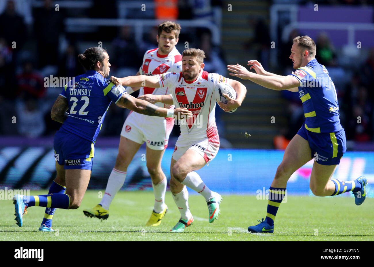 St. Helens Tom Makinson is tackled by Warrington's Gene Ormsby and Ben Currie during the Magic Weekend match at St James' Park, Newcastle. Stock Photo