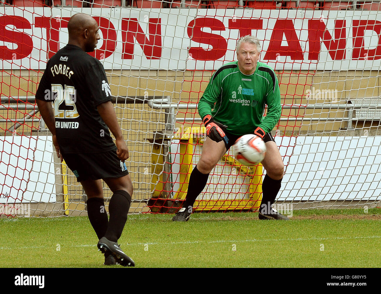 Men United team member TV builder Tommy Walsh (right) in action at the Leyton Orient Football Club, London, where Errol McKellar's Prostate Cancer UK charity match was played, in aid of Prostate Cancer UK. Stock Photo