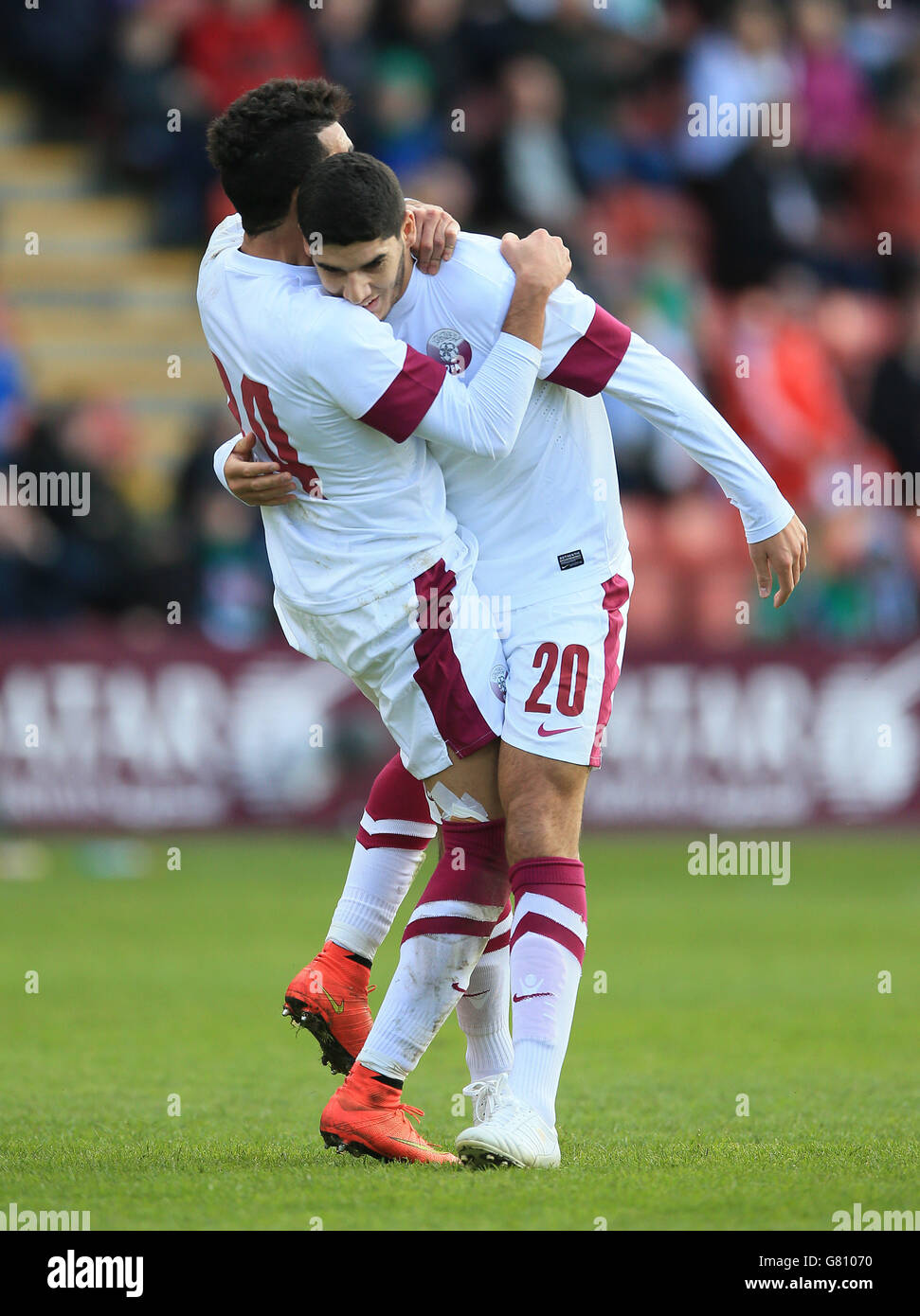 Qatar's Karim Boudiaf (right) celebrates scoring his sides first goal of the game against Northern Ireland with Ahmed Yasser. Stock Photo