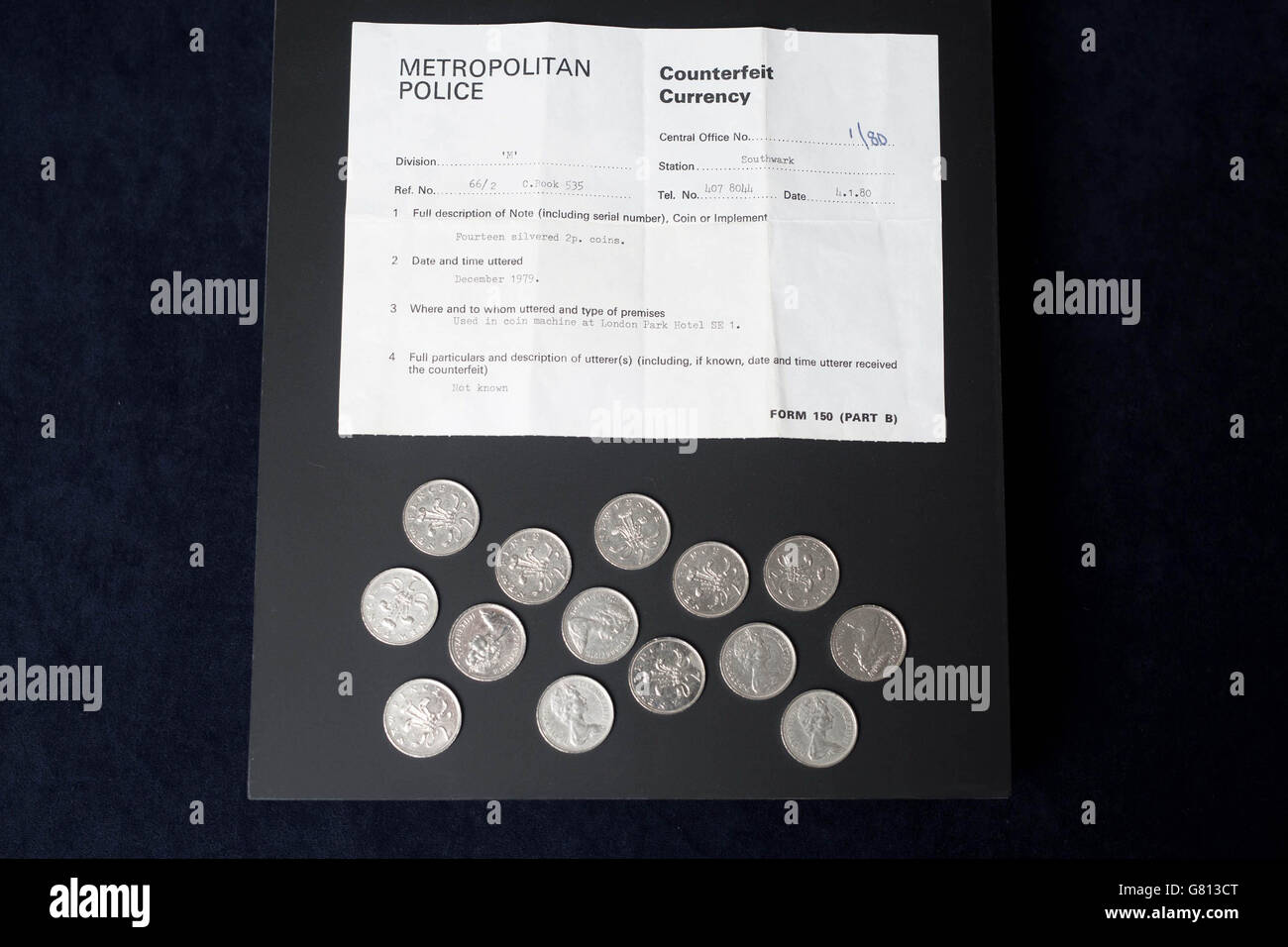 EDITORIAL USE ONLY Fourteen counterfeit silvered 2p coins seized by Metropolitan Police in 1979, which is some of six never-before-seen objects from the Metropolitan Police's hidden Crime Museum, at a preview for the Crime Museum Uncovered exhibition at the Museum of London that will open to the public on 9 October 2015. Stock Photo