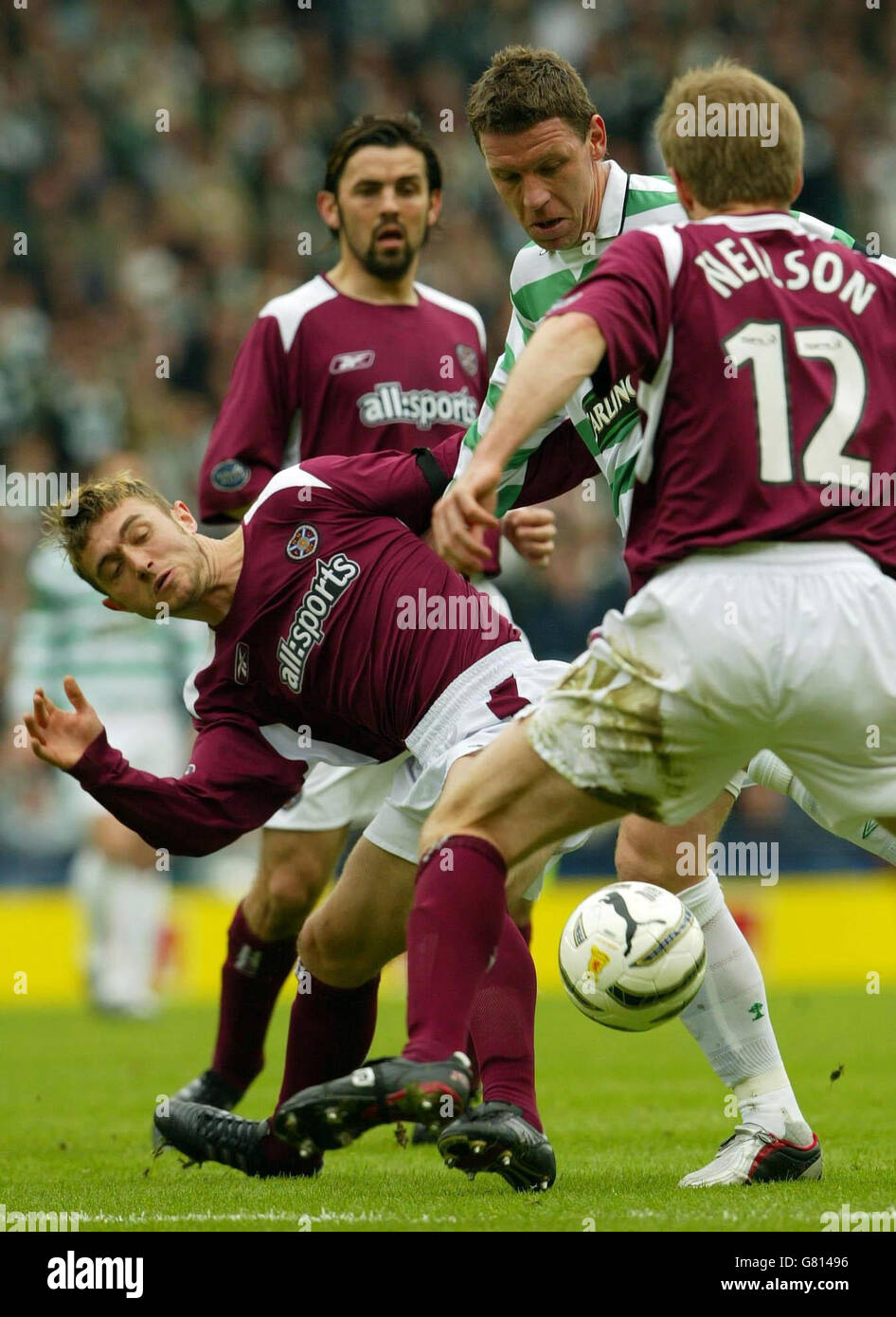 Soccer - Tennents Scottish Cup - Semi-Final - Heart of Midlothian v Celtic - Hampden Park. Celtic's Alan Thompson (C) pushers past Hearts' Lee Wallace (L) and Robbie Neilson. Stock Photo