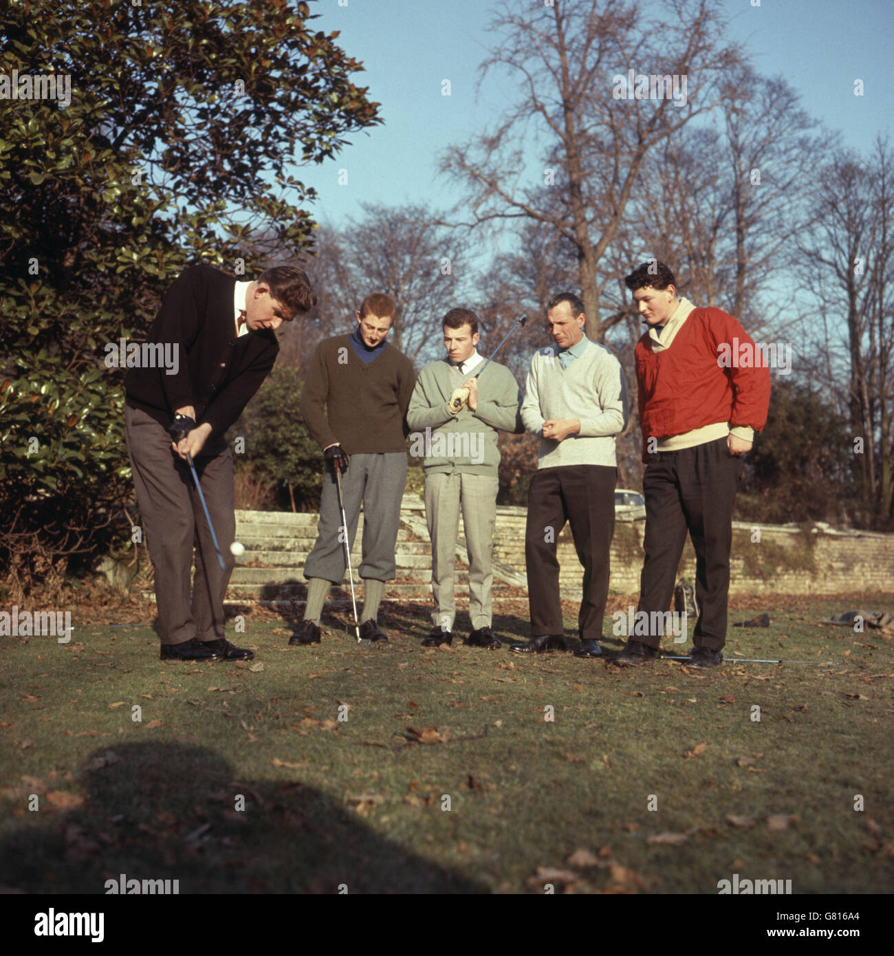 Max Faulkner is seen (2nd from left) during a coaching session with four Butten Boys, Britain's young golfing hopes, at Sundridge Park, Kent, who are being given his specialist training and management. Playing is Alan Ibberson, 22 from Worksop, and the others are (l-r) Iain Clark, 17 from St. Andrews, Tommy Horton, 23 from Jersey and Brian Barnes, 19 from Somerset. Stock Photo