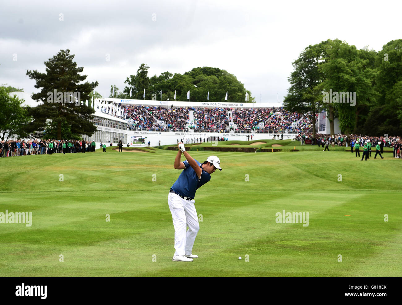 Korea's Byeong Hun An plays on to the 18th green during day four of the 2015 BMW PGA Championship at the Wentworth Golf Club, Surrey. Stock Photo