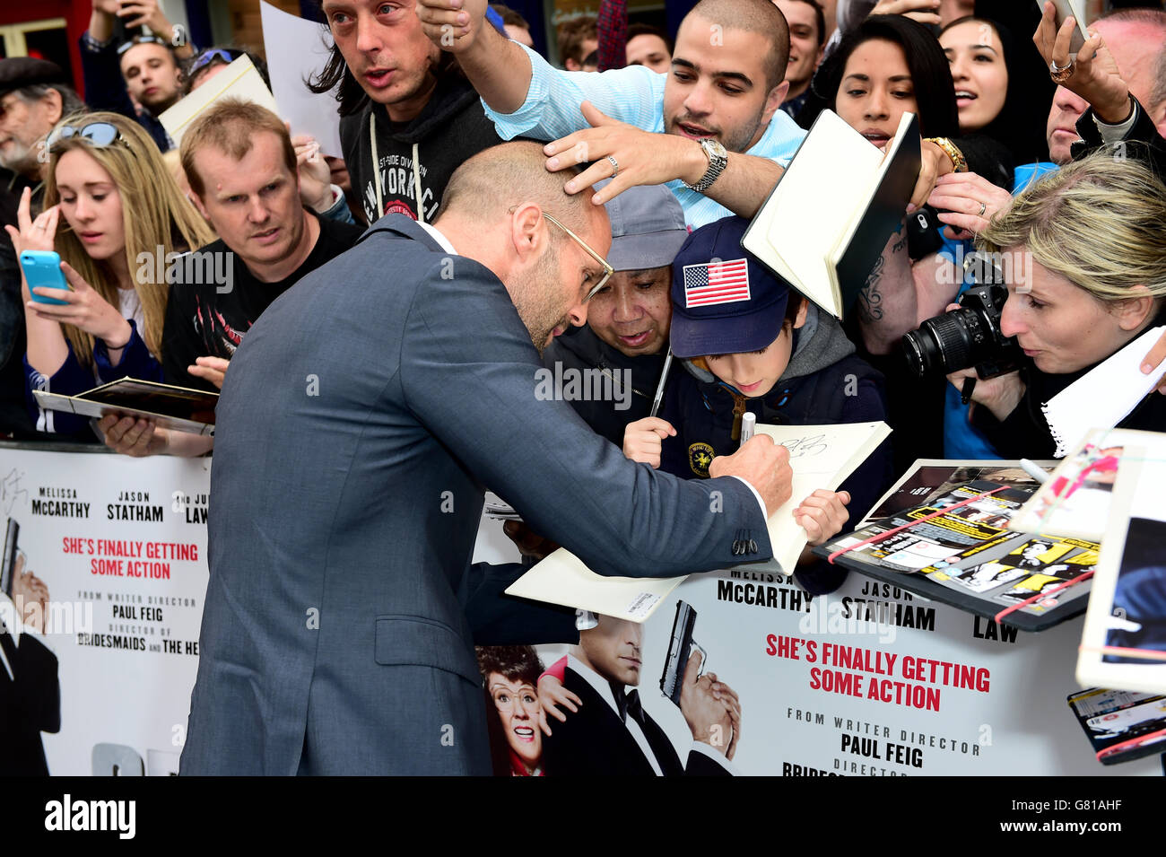 Jason Statham signs autographs for fans as he attends the European premiere  of Spy at the Odeon Leicester Square, London. PRESS ASSOCIATION Photo.  Picture date: Wednesday May 27, 2015. Photo credit should