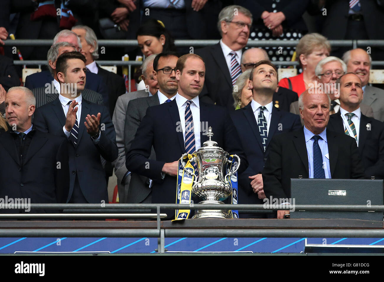 The Duke of Cambridge, President of The Football Association (centre) prepares to award the FA Cup trophy following the FA Cup Final at Wembley Stadium, London. PRESS ASSOCIATION Photo. Picture date: Saturday May 30, 2015. See PA Story SOCCER FA Cup. Photo credit should read: Nick Potts/PA Wire. RESTRICTIONS: Maximum 45 images during a match. No video emulation or promotion as 'live'. No use in games, competitions, merchandise, betting or single club/player services. No use with unofficial audio, video, data, fixture Stock Photo