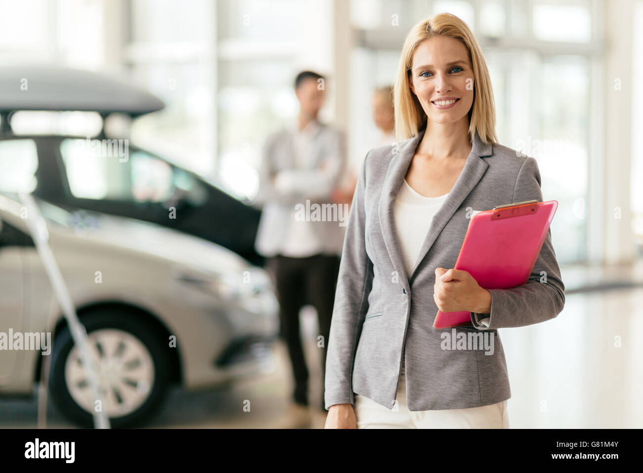 Professional salesperson at car dealership Stock Photo