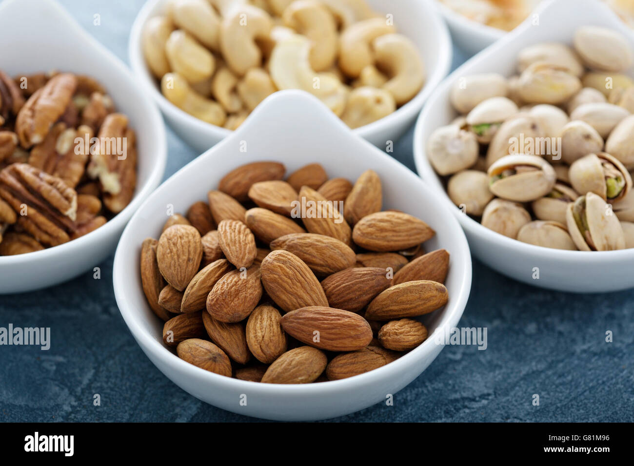 Variety of nuts in small bowls Stock Photo Alamy