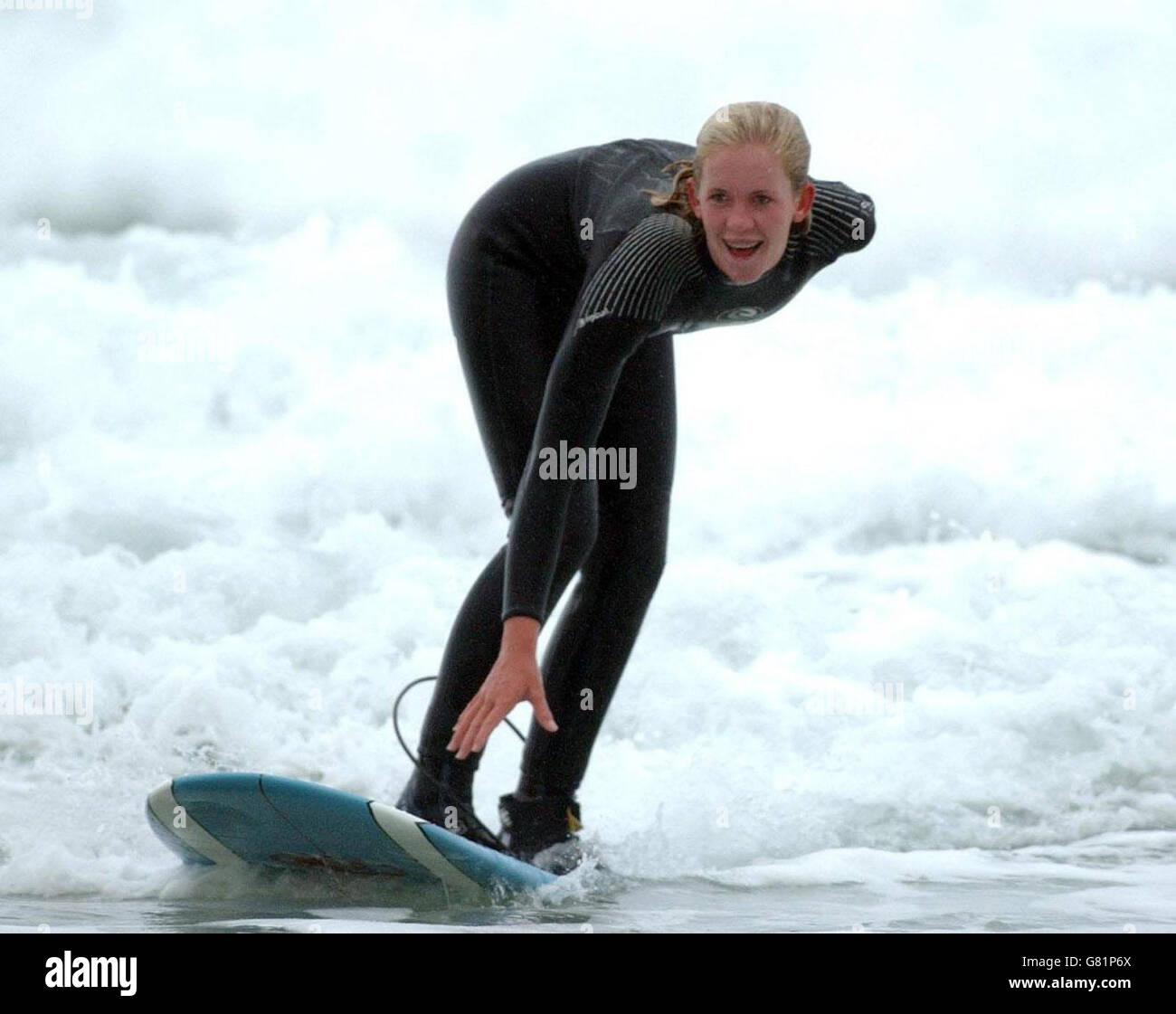 Bethany Hamilton, 15, takes to the waves in Watergate Bay, near Newquay, where she was teaching new Blue Peter presenter Gethin Jones, 26, to surf for a future episode of the children's TV programme. The teenage surfer from Hawaii lost her left arm when she was attacked by a 14ft tiger shark while she was surfing near Tunnels Beach on Kauai on October 31, 2003, when she was 13. Stock Photo
