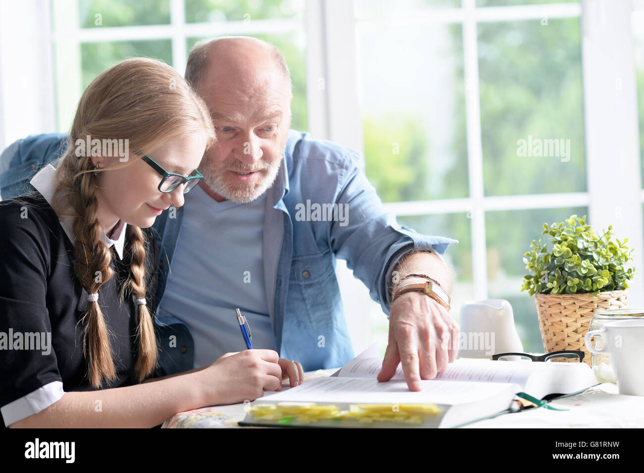 grandfather and granddaughter doing homework Stock Photo Alamy