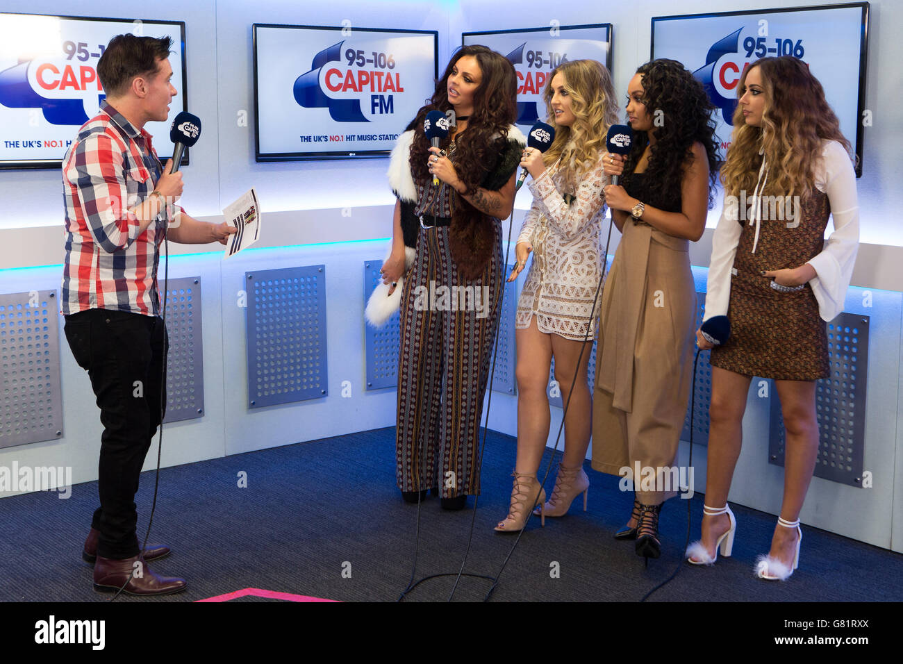 Capital FM presenter Greg Burns (L) and ( L to R) Jesy Nelson, Perrie Edwards, Leigh-Anne Pinnock and Jade Thirlwall from Little Mix during an interview at Capital FM Summertime Ball Radio studio, Wembley Stadium, London. Daniel Leal-Olivas/PA Showbiz Stock Photo