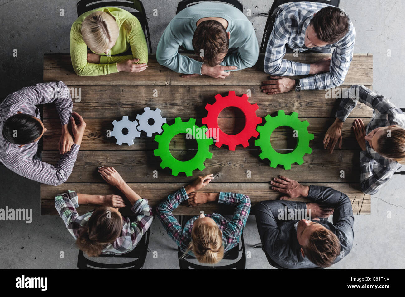 Hipster business team and cogs brainstorming planning meeting concept Stock Photo