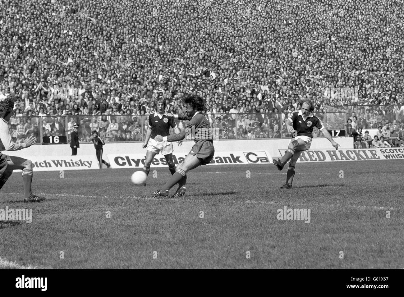 Scotland's Archie Gemmill (r) fires the opening goal past Northern Ireland's Pat Jennings (l) and Peter Scott (second r), watched by teammate Kenny Dalglish (second l) Stock Photo