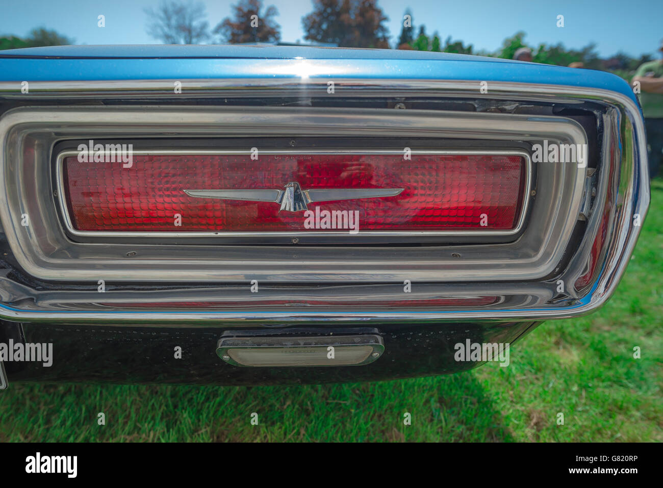 Detail of the rear light of a blue 1960s Ford Thunderbird car. Stock Photo