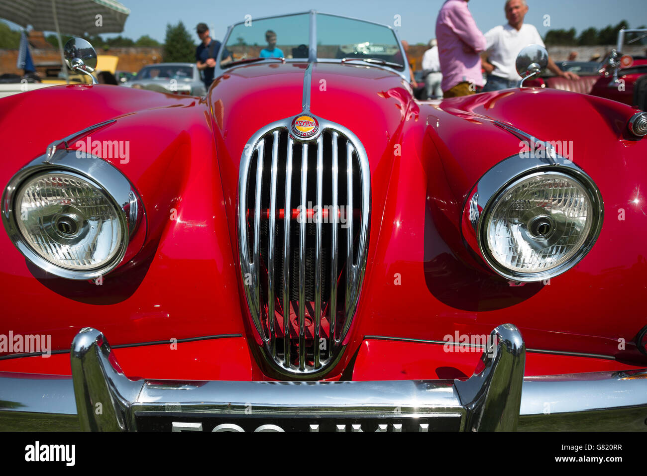 Detail of the front of a red  1950s Jaguar 3.4 litre sports car. Stock Photo